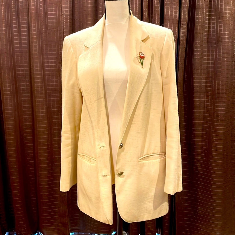 Cream colored polyester blazer.